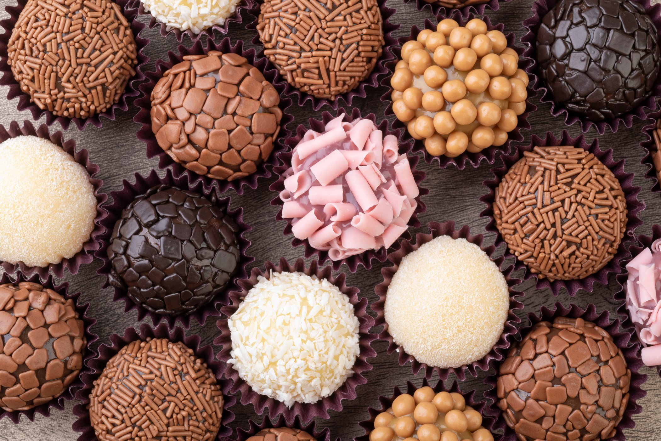 Typical brazilian brigadeiros, various flavors over wooden table